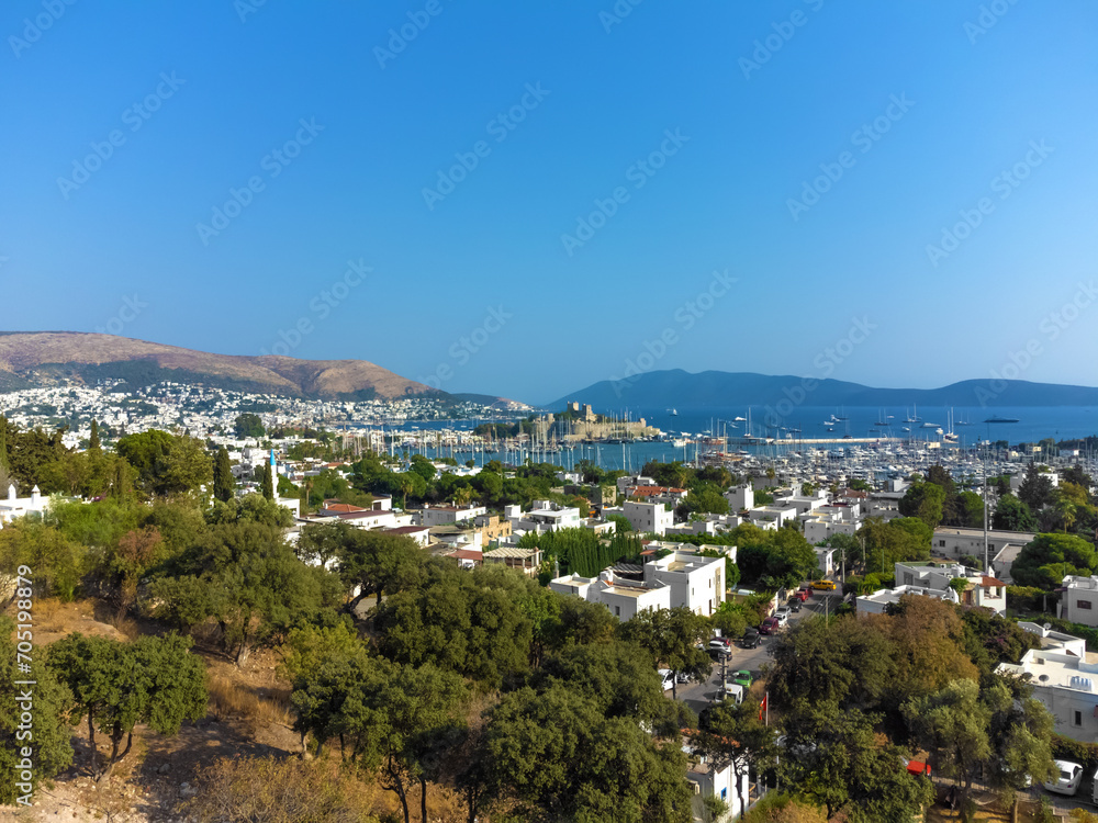 Beautiful scenery of Bodrum city, marina and ancient St. Peter's Castle or Kalesi Castle on a sunny day, Turkey.