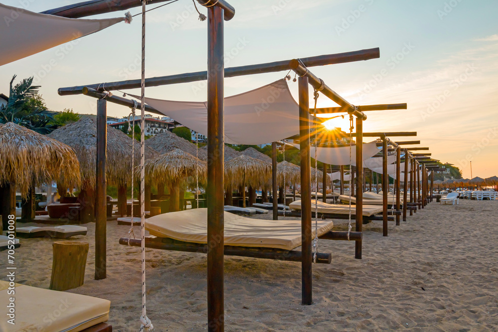 Sunrise, morning on the beach in the town of Saint Vlas, Bulgaria. An empty beach bathed in sunlight. Sunrise, morning on the beach in the town of Saint Vlas, Bulgaria. An empty beach bathed in sunlight.