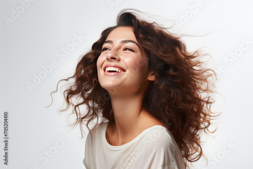 long-haired brunette girl smiling on a white background
