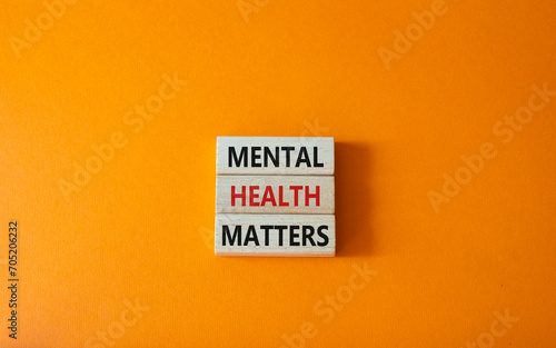 Mental Health Matters symbol. Concept words Mental Health Matters on wooden blocks. Beautiful orange background. Healthcare and Mental Health Matters concept. Copy space.