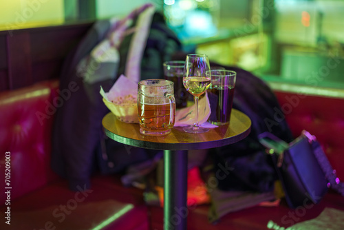 Close-up view of various drinks in glasses on small bar table at bowling center  with blurred background. Sweden.