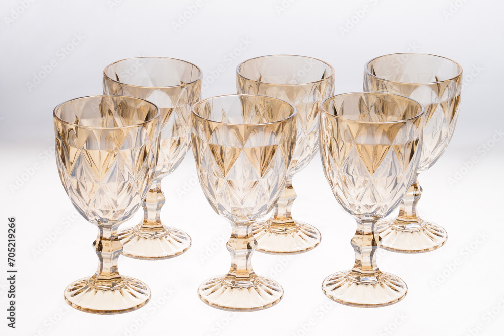 Set of empty gold crystal glasses isolated on white background Set of empty gold crystal glasses isolated on white background