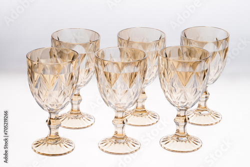Set of empty gold crystal glasses isolated on white background