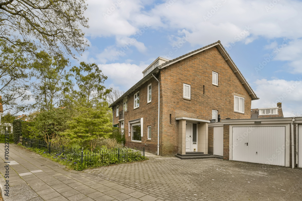 brick house with a garage and a driveway brick house with a garage and a driveway