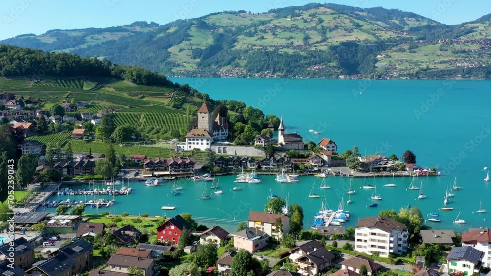 Aerial panoramic view of Spiez Church and Castle on the shore of Lake Thun in the Swiss canton of Bern at sunset, Spiez, Switzerland. Spiez Castle on lake Thun in the canton of Bern, Switzerland.