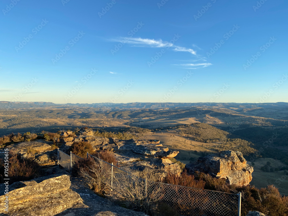 Sunset over the mountains. Spectacular views from a mountain-top lookout. Mountains in the horizon. Blue mountains, Australia. Grand canyon sunset. Unusual rock formation. Summit of the mountain.