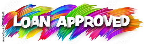 Loan approved paper word sign with colorful spectrum paint brush strokes over white.