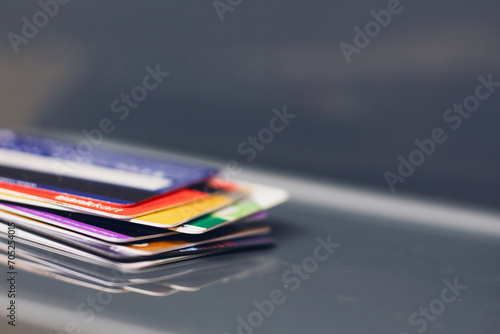 Stack of different colorful credit cards. Close up view with selective focus for background. Credit card payment for purchases from online shopping.