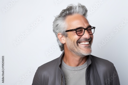 Portrait of a happy senior man with grey hair and eyeglasses