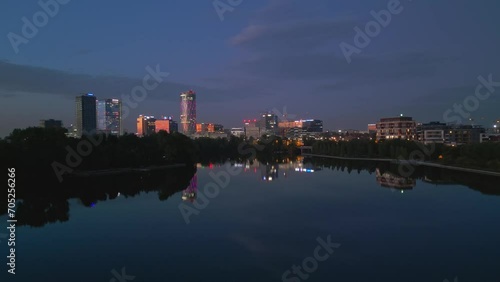 Establishing Aerial Shot Of Bucharest City Skyline And Lake Floreasca At Blue Hour photo