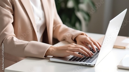 A businesswoman is typing on her laptop,