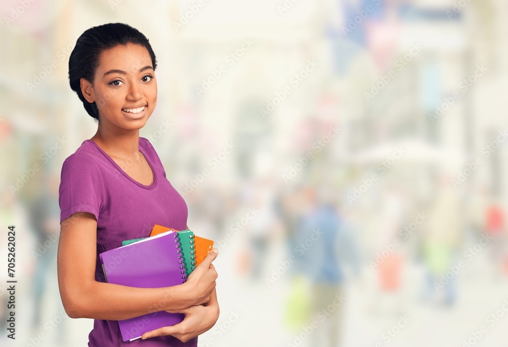 Positive young female student hold books