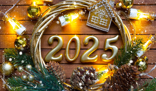 Happy New Year golden numbers 2025 on cozy festive brown wooden background with sequins, snow, lights of garlands. Greetings, postcard. Calendar, cover © Ольга Симонова