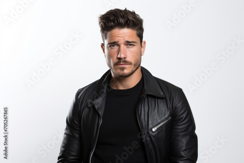 Handsome young man in black leather jacket on white background.