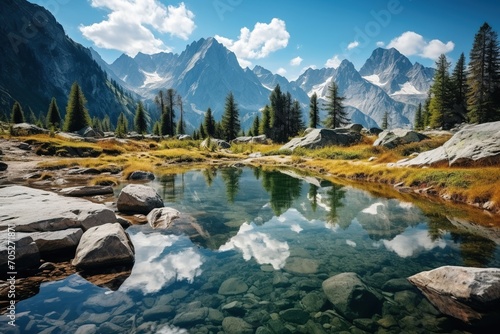 Mountain lake in the Alps with crystal clear water reflecting the sky