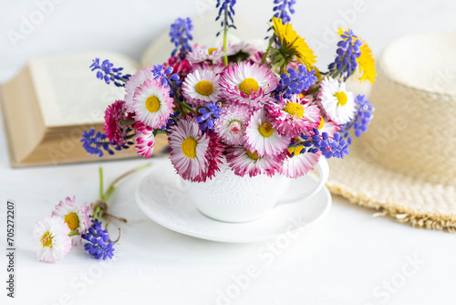 Greeting card for Women s or Mother s Day  8th of March. Beautiful spring or summer floral composition with daisy camomile flowers in a white cup for countryside table decor. Wooden background