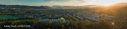Early morning panorama of Koseze pond or koseski bajer with a modern city hlock on the right. Picturesque morning of siska, a ljubljana suburb. Sun just rising up.