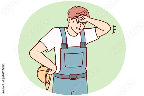 Tired man in construction uniform and safety helmet wiping forehead after completing difficult project. Sweaty guy foreman wearily looks down exhausted at end of day. Flat vector design