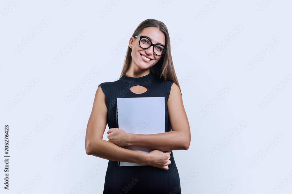 Young business woman with clipboard looking at camera on white background Young business woman with clipboard looking at camera on white background