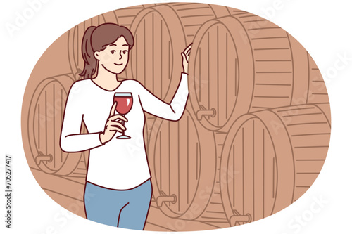 Woman with glass of wine stands near wooden barrel for tincture of alcoholic drink and looks at screen. Positive lady in casual clothes walking alone in winery cellar. Flat vector illustration