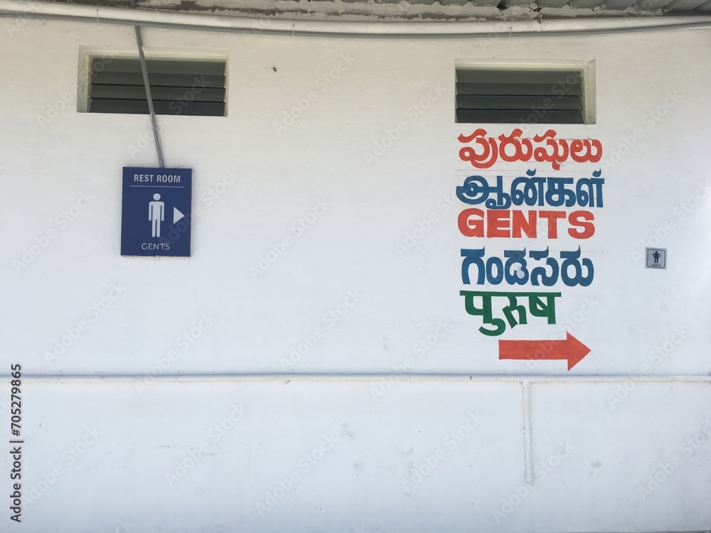 Gents Toilet signage in multiple languages in India. Washroom signs and directions indicate the