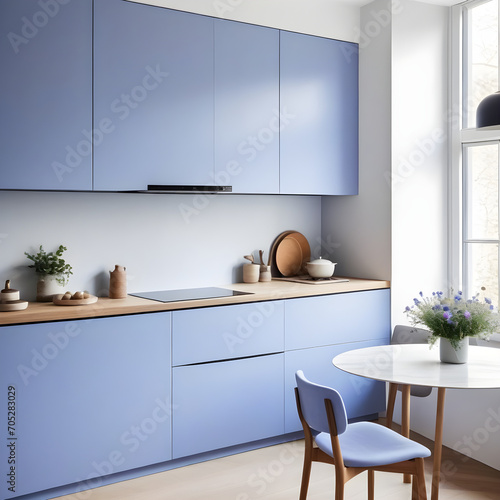 Beautiful bright calm kitchen interior detail with soft periwinkle cornflower blue cabinets with minimal modern furnishing 