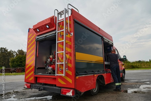 A state-of-the-art firetruck, equipped with advanced rescue technology, stands ready with its skilled firefighting team, prepared to intervene and respond rapidly to emergencies, ensuring the safety