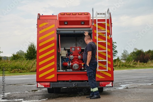 A state-of-the-art firetruck, equipped with advanced rescue technology, stands ready with its skilled firefighting team, prepared to intervene and respond rapidly to emergencies, ensuring the safety