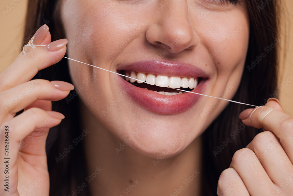 Beautiful Female Using Dental Floss And Smiling At Camera Beautiful Female Using Dental Floss And Smiling At Camera