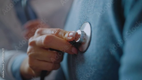 Cropped view of the woman doctor holding stethoscope and checking breath sound