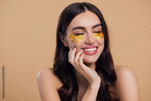 Принти на полотні Woman standing naked isolated looking camera take care of her skin with under ey