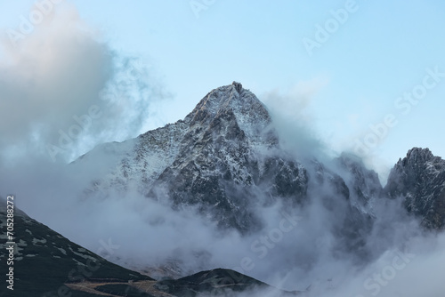 Lomnický Peak is one of the highest mountain peaks in the High Tatras mountains of Slovakia. The peak of the mountain is shrouded in clouds in the evening. There is an observatory on the rock.