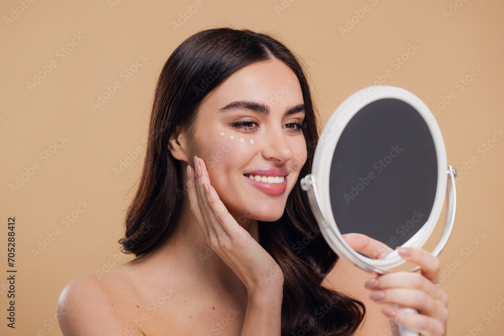 Woman Applying Eye Cream Drops On Skin Under Eyes and Looking in Mirror Woman Applying Eye Cream Drops On Skin Under Eyes and Looking in Mirror