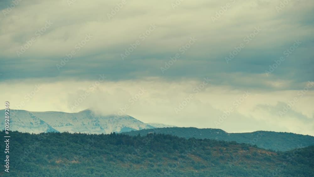 Time lapse. Clouds moving over mountain landscape with Mont Ventoux in the distance, view from Baronnies Provencales Natural Park in France. Time lapse. Clouds moving over mountain landscape with Mont Ventoux in the distance, view from Baronnies Provencales Natural Park in France.