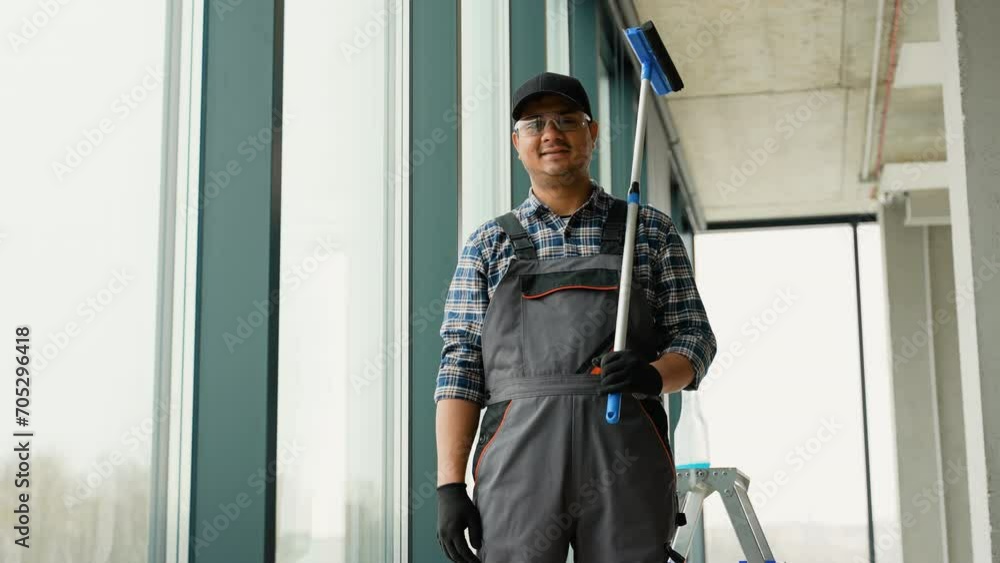 Portrait of window washer in office. Professional window washing service Portrait of window washer in office. Professional window washing service