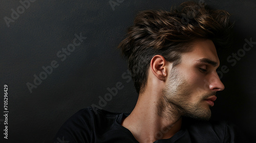 Handsome man with closed eyes on a dark background