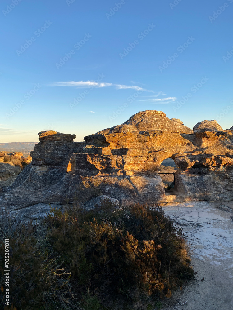 Arched cave entrance. Spectacular views from a mountain-top lookout. Mountains in the horizon. Blue mountains, Australia. Grand canyon sunset. Unusual rock formation. Summit of the mountain.