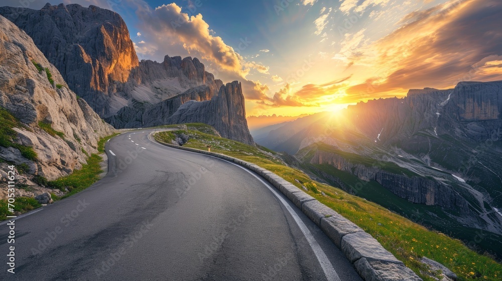 Mountain road at colorful sunset in summer. Dolomites, Italy. Beautiful curved roadway, rocks, stones, blue sky with clouds. Landscape with empty highway through the mountain pass in spring. Travel - obrazy, fototapety, plakaty 