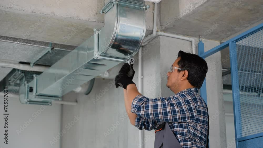 Hvac technician at work. Ventilation system installation and repair service Hvac technician at work. Ventilation system installation and repair service
