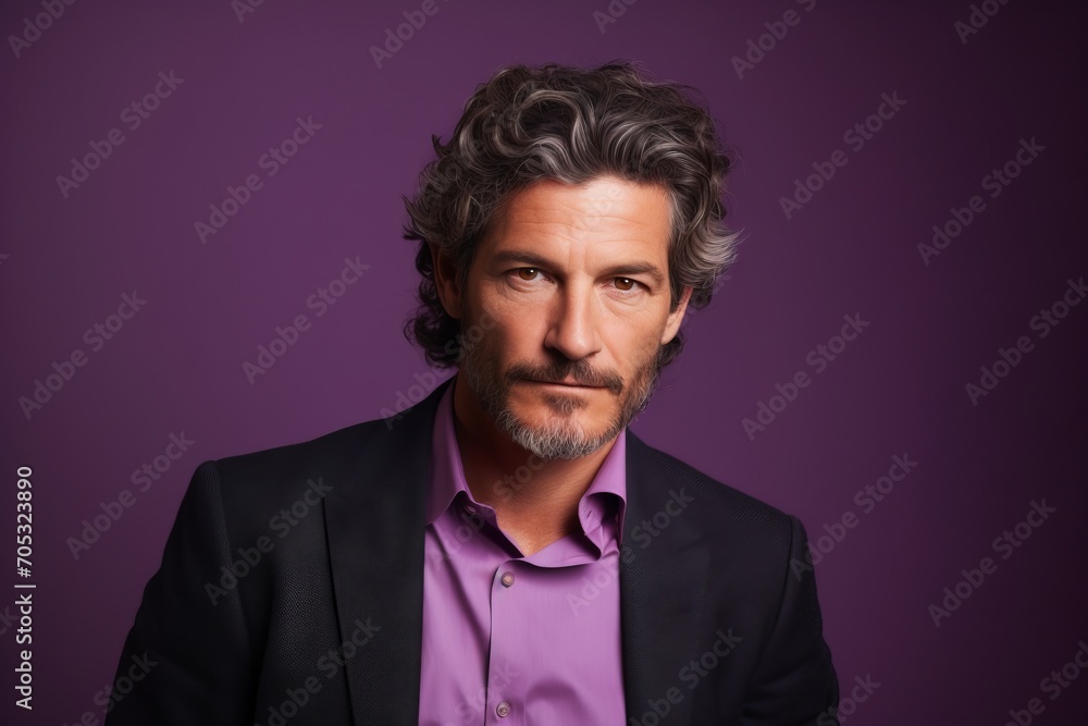 Portrait of a handsome middle-aged man on a purple background. Portrait of a handsome middle-aged man on a purple background.