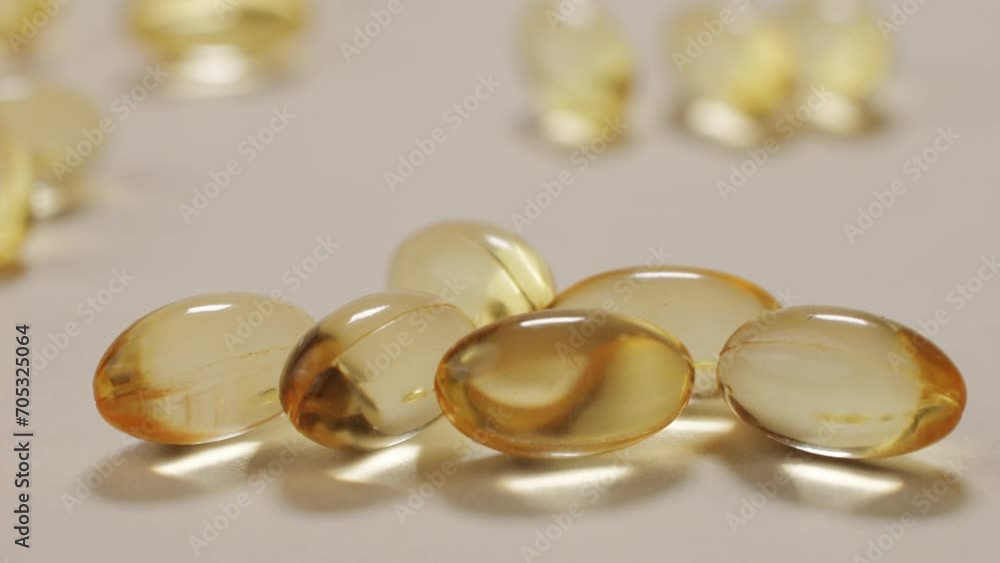 Omega fish oil pills dietary supplement falling down on white background. Omega fish oil softgels dietary supplement background. Healthy life and heart health concept. Omega fish oil pills dietary supplement falling down on white background. Omega fish oil softgels dietary supplement background. Healthy life and heart health concept.