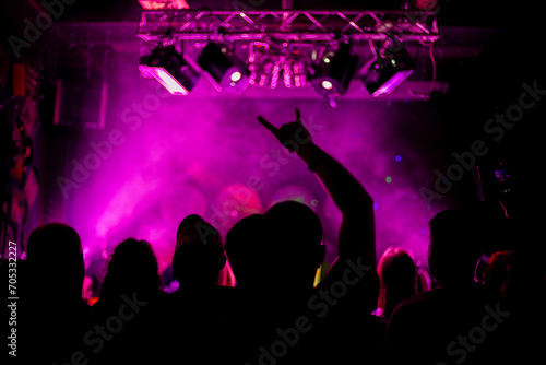 Nightlife and disco concept. Young people are dancing in club or outdoor in sunlight. Happiness, holidays, youth concepts. Female and male hands and silhouettes in smoke