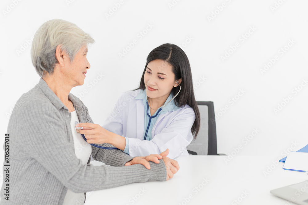 Asian doctor talk with old female patient about disease symptom, doctor use stethoscope listening lung and heart of patient, elderly health check up, happiness hospital Asian doctor talk with old female patient about disease symptom, doctor use stethoscope listening lung and heart of patient, elderly health check up, happiness hospital