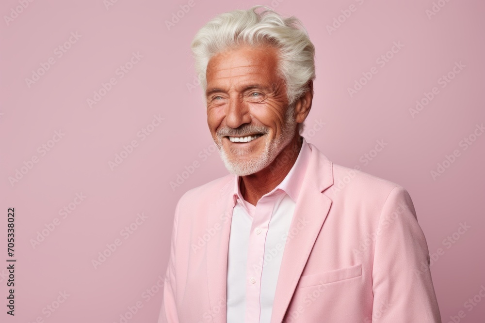 Portrait of happy senior man with white hair and beard smiling at camera while standing against pink background Portrait of happy senior man with white hair and beard smiling at camera while standing against pink background