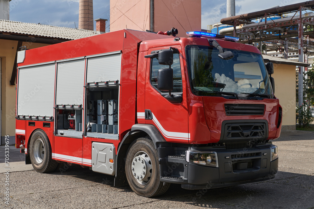 Fototapeta premium A state-of-the-art firetruck, equipped with advanced rescue technology, stands ready with its skilled firefighting team, prepared to intervene and respond rapidly to emergencies, ensuring the safety