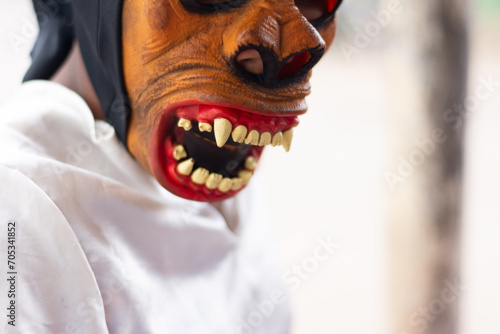 An unidentified person is seen wearing a horror costume and mask in the Acupe district in the city of Santo Amaro, Bahia. photo