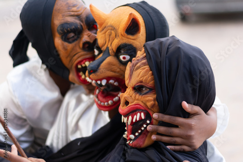 Unidentified people are seen wearing horror costumes and masks in the Acupe district in the city of Santo Amaro, Bahia. photo