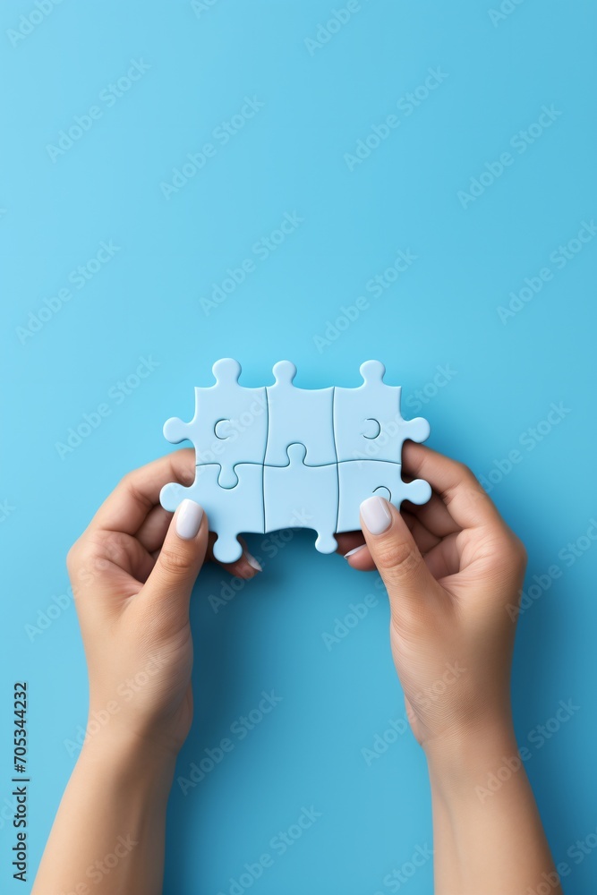 Blue puzzle pieces in caucasian female hands on blue background Blue puzzle pieces in caucasian female hands on blue background