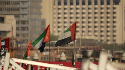 Wallpaper Mural United Arab Emirates flags waving in Dubai old city of Deira in sunset, slow motion Torontodigital.ca