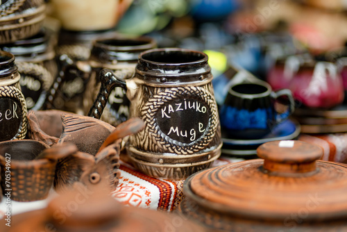 Ceramic dishes, tableware and jugs sold on Easter market in Vilnius. 'Kaziuko muge' means 'Kaziukas fair' in Lithuanian.